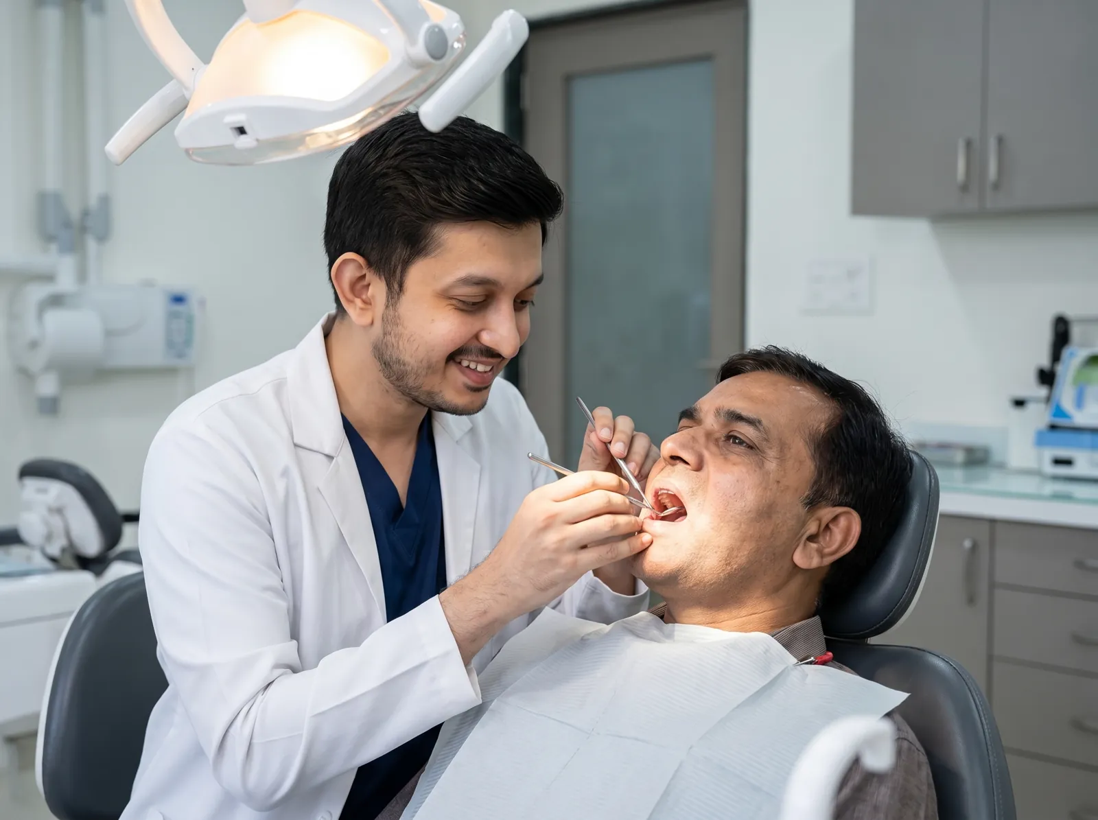 Dr. Chinmay examining a patient's teeth during a routine dental checkup in Mehsana