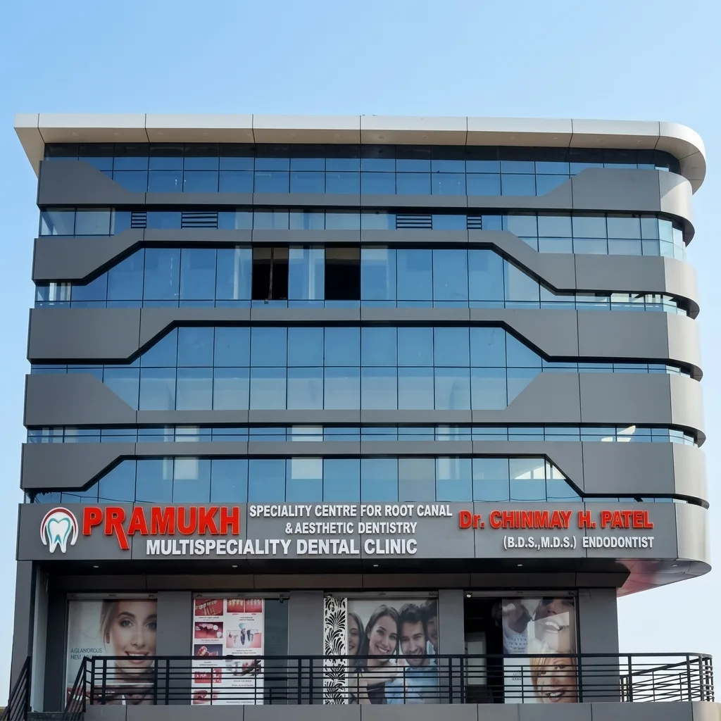Exterior of Pramukh Multispeciality Dental Clinic at Radhanpur Circle, Mehsana, showing the red signage